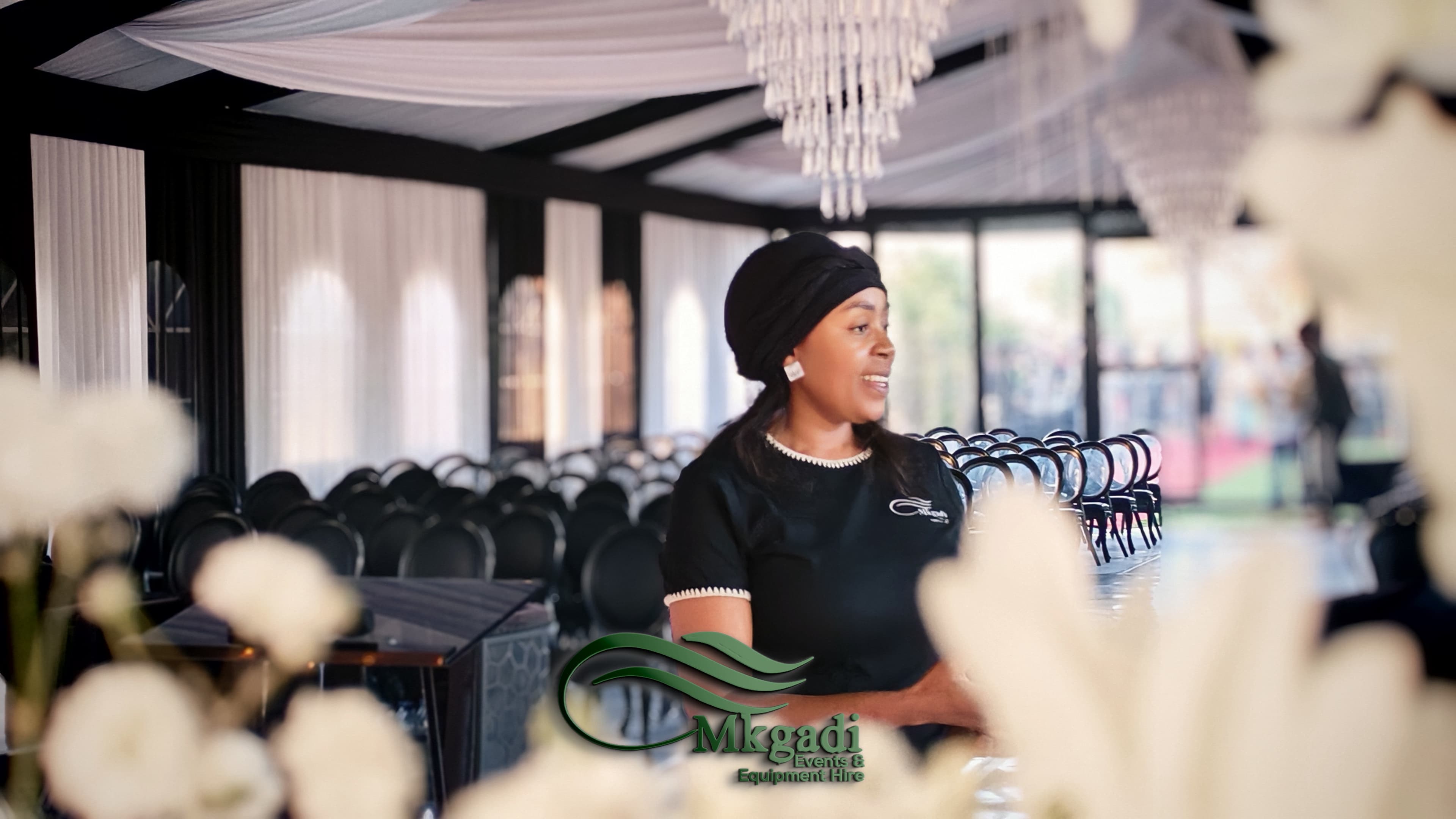Grand event hall transformation with decorative draping, chandeliers and formal table settings for a gala evening